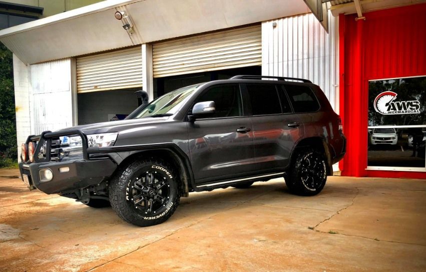 A Dark Gray SUV With A Black Brush Guard And Large Off-road Tires — AWS Mechanical in Stuart Park, NT