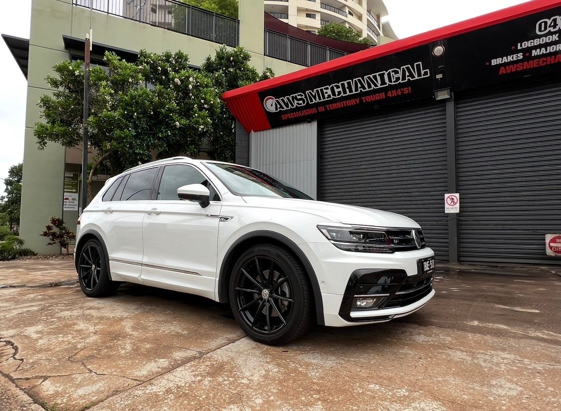 A White subaru car is parked in front of a garage — AWS Mechanical in Stuart Park, NT