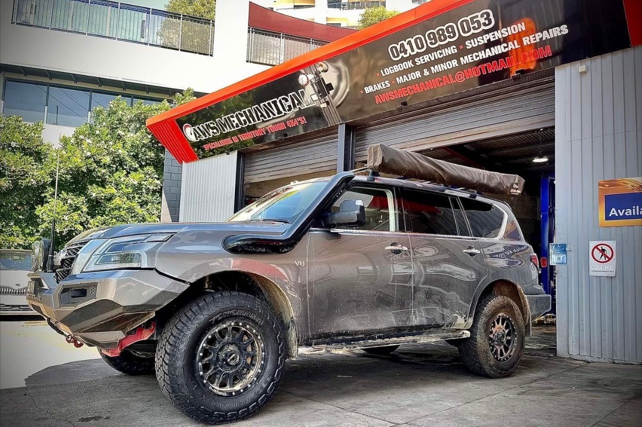 A Dirty Grey Car is parked outside a mechanics garage — AWS Mechanical in Stuart Park, NT