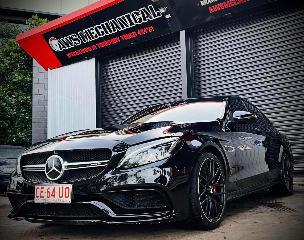 A Black BMW is parked in front of a garage — AWS Mechanical in Stuart Park, NT