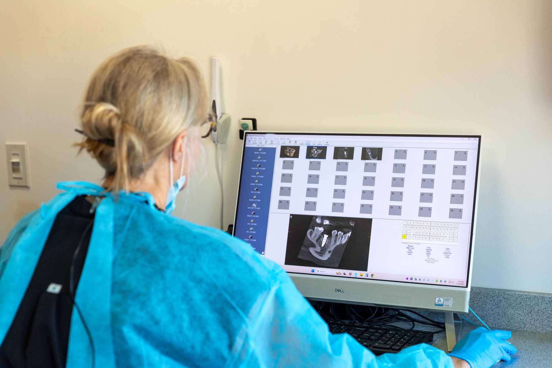 Person viewing medical scan on a computer monitor in a clinical office