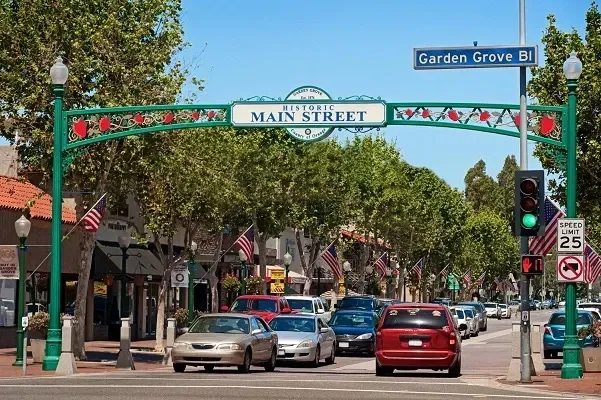 Cars are driving down main street in a small town