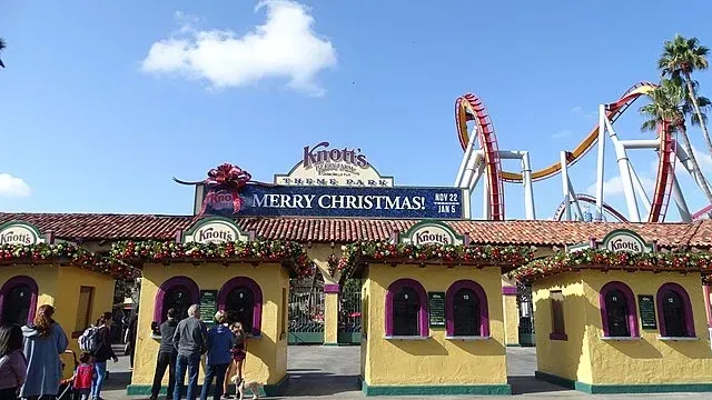 A group of people standing in front of a merry christmas sign