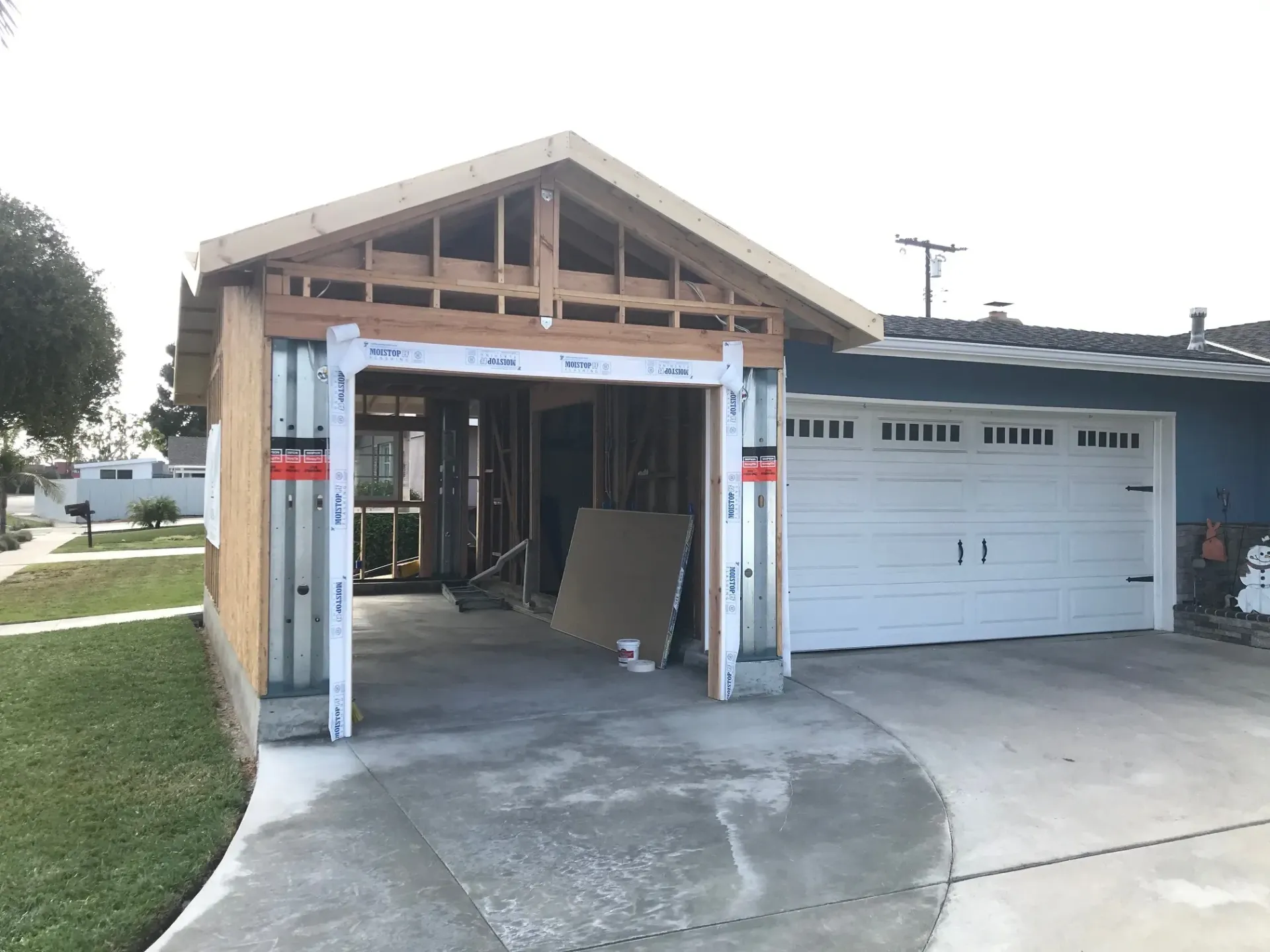 A garage is being built into the side of a house.