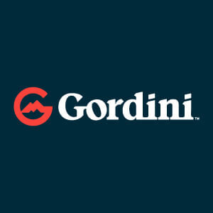Gordini logo in white and red on a dark teal background