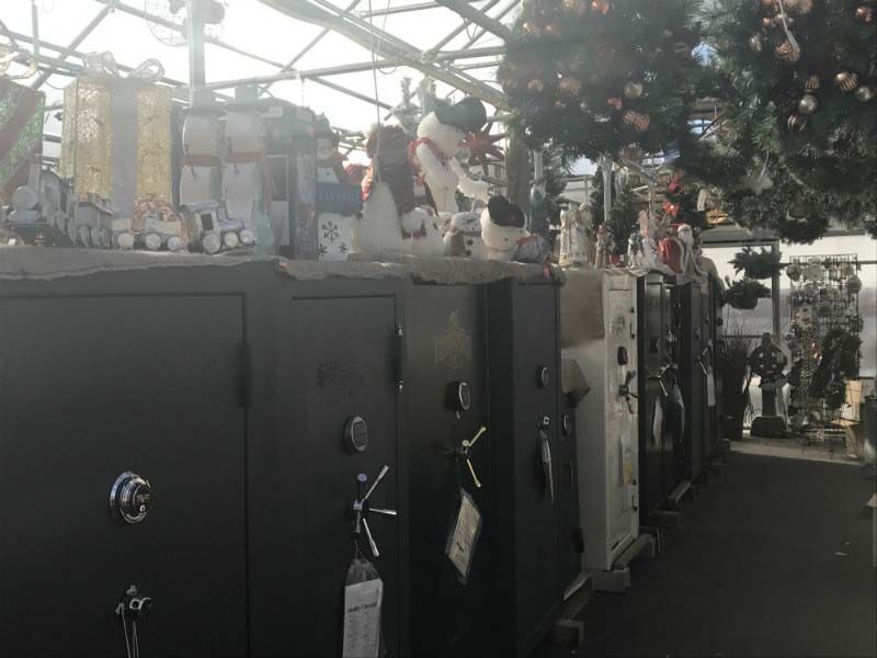 Row of black portable toilets under a canopy at an outdoor event