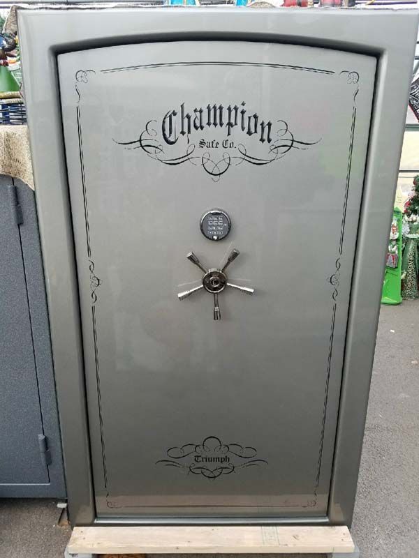 Gray Champion safe with ornate door and combination lock in a store display area