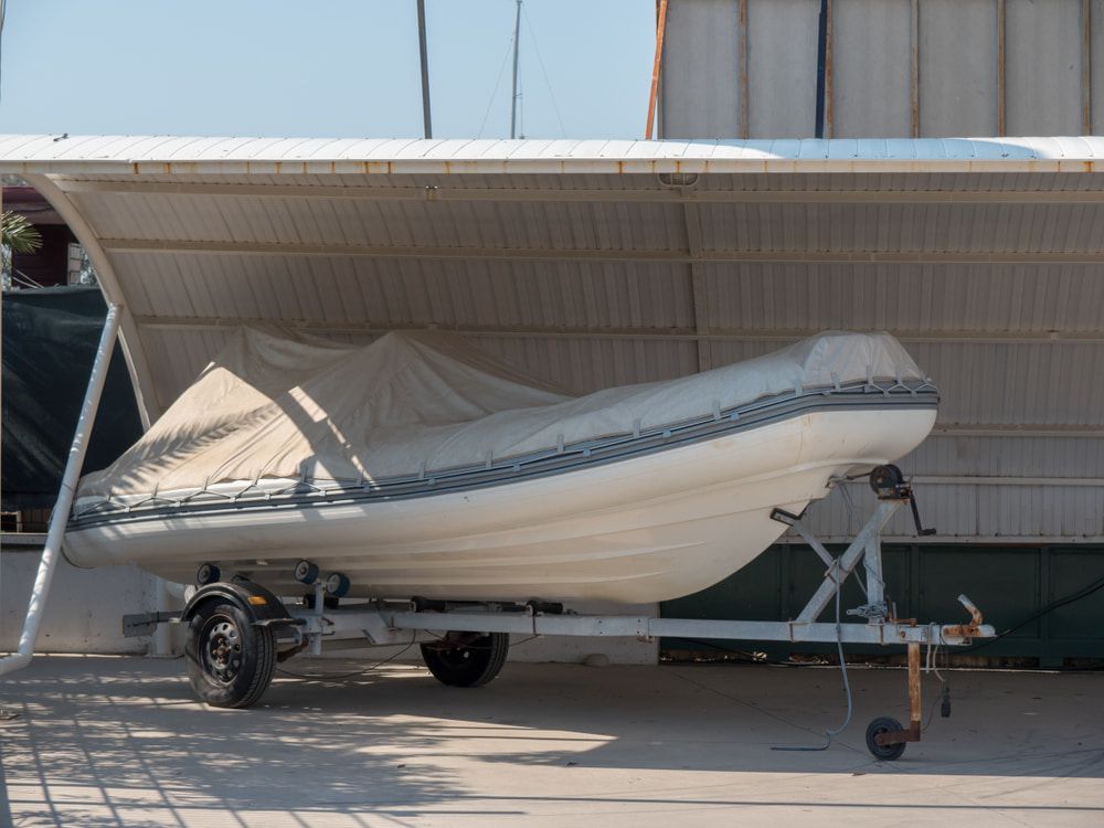 A Boat on a Trailer Under a White Canopy — Bay & Basin Storage In St Georges Basin, NSW