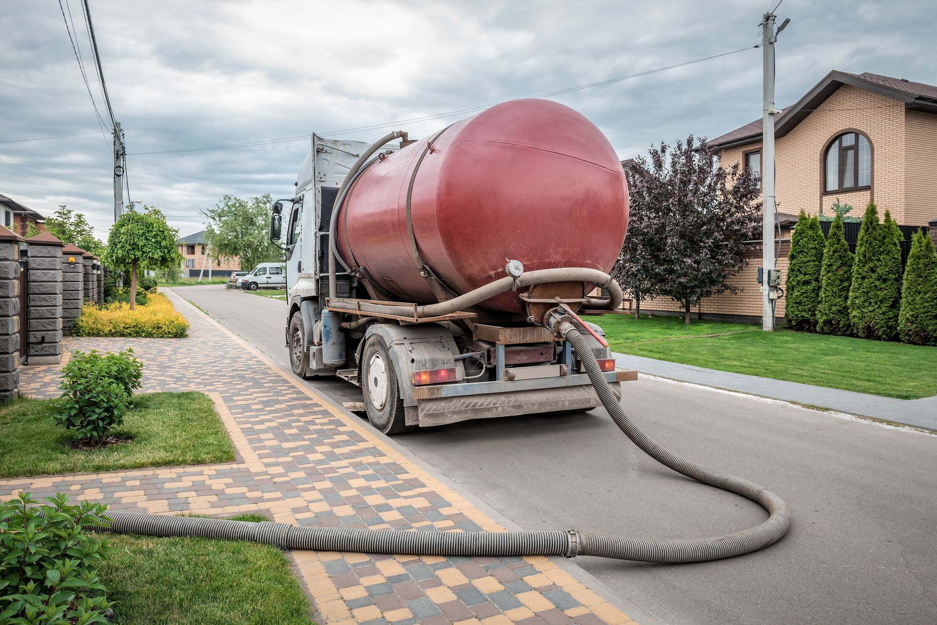 Septic pumping truck servicing a residential septic system.