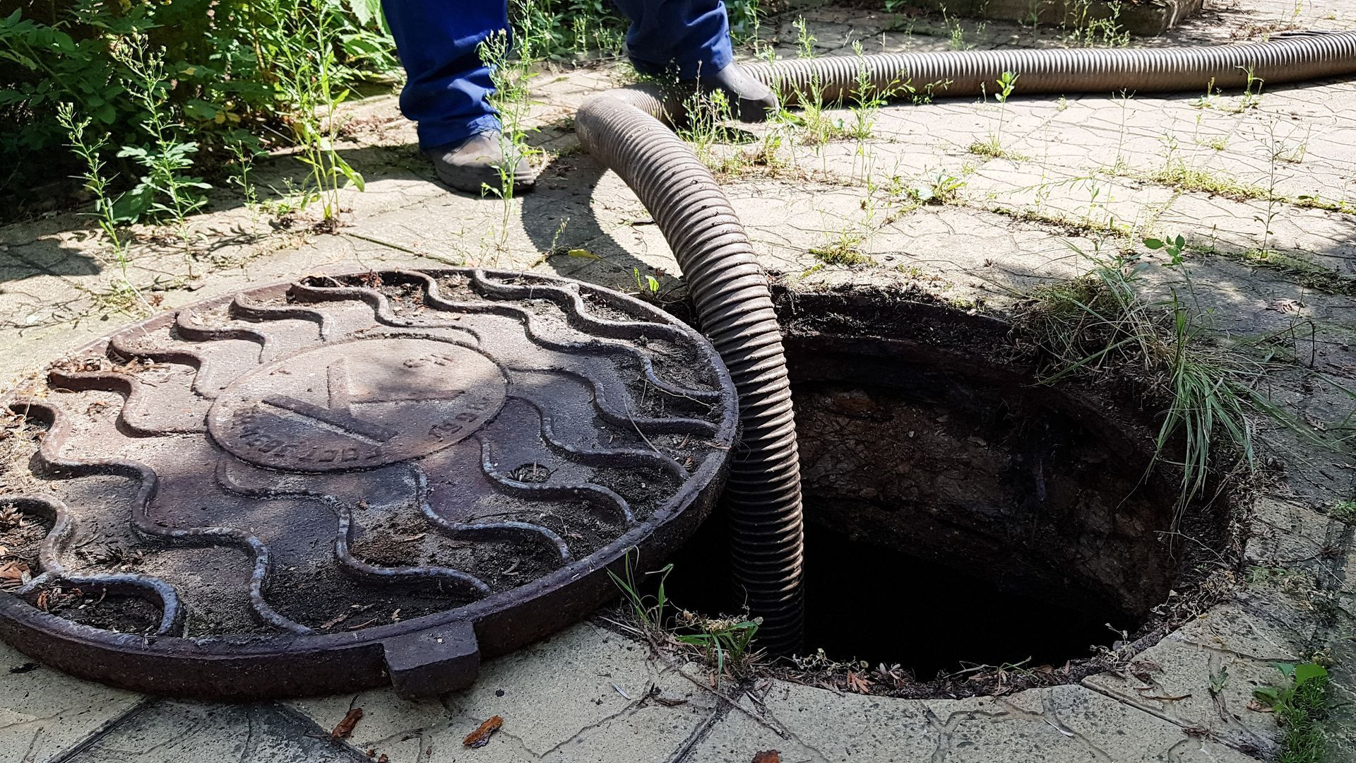 A man is providing septic tank cleaning services. A man is providing septic tank cleaning services.