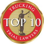 Red and gold “Top 10 Trial Lawyers” trucking award badge with a silhouetted figure in the center
