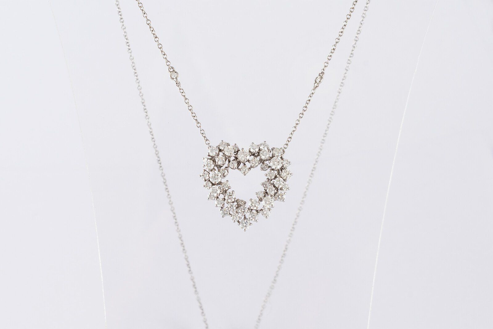 Gold heart-shaped pendant necklace on a white background