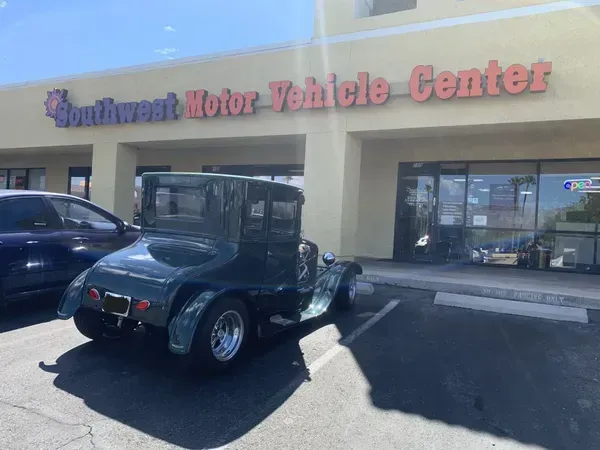 Green antique car parked in front of