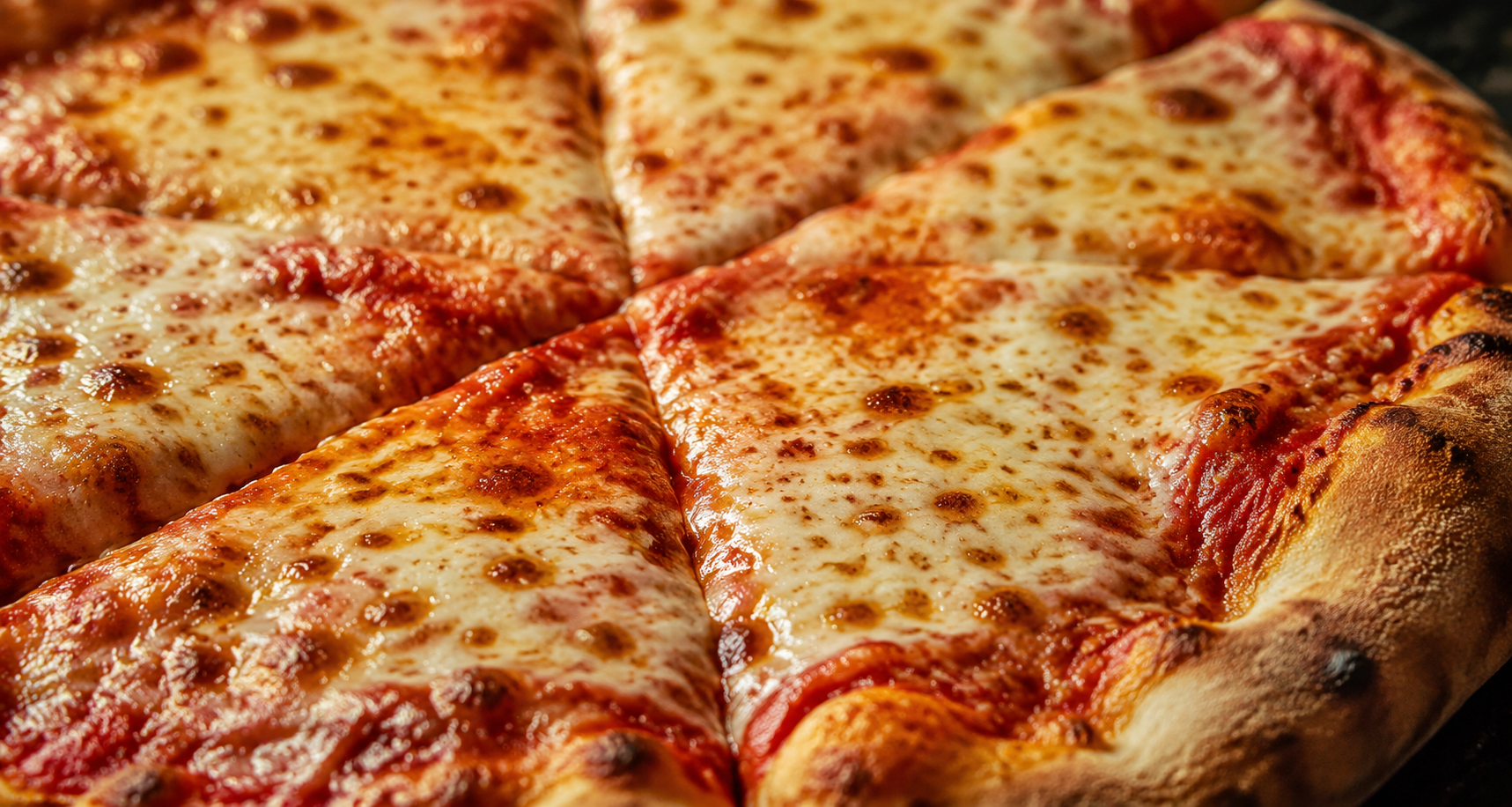 Close-up of a cheese pizza with golden crust and red sauce, sliced into wedges