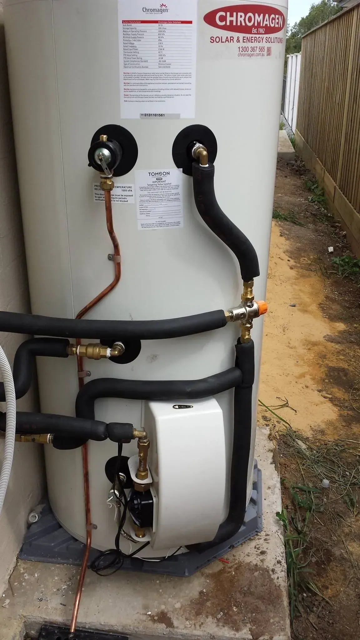 Tall White Water Heater With Black and Copper Pipes — Medowie Plumbing & Gas in in Newcastle