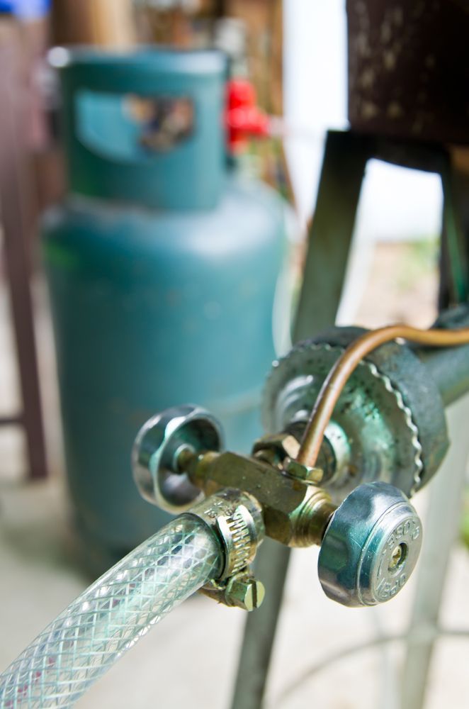 A Close up Of a Gas Cylinder with A Hose Attached to It — Medowie Plumbing & Gas In Medowie, NSW