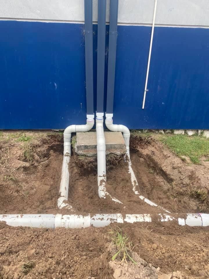 White PVC Pipes Against a Blue Wall — Medowie Plumbing & Gas in in Newcastle