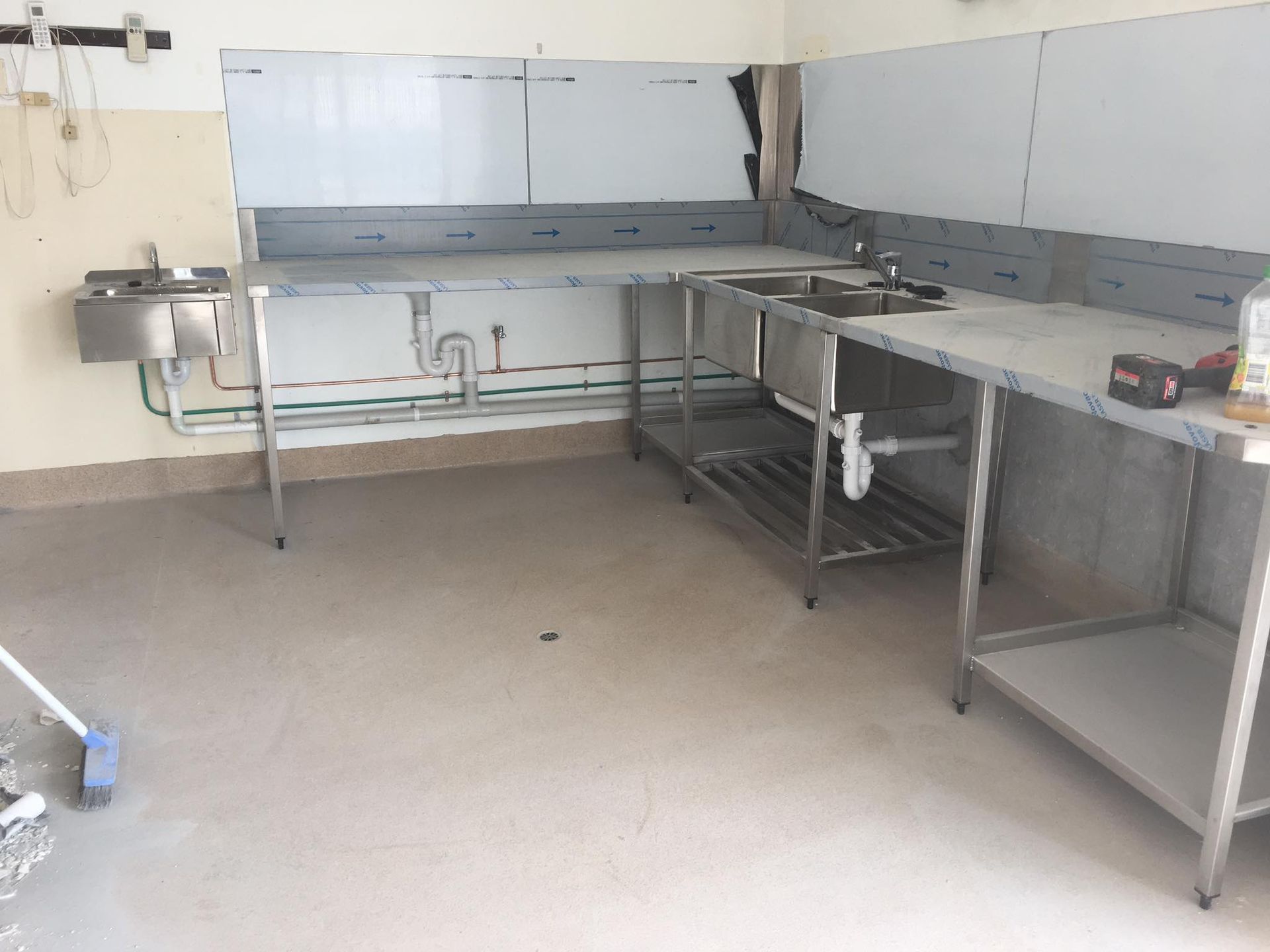 Empty Industrial Kitchen With Stainless Steel Counters and Sinks — Medowie Plumbing & Gas in in Newcastle