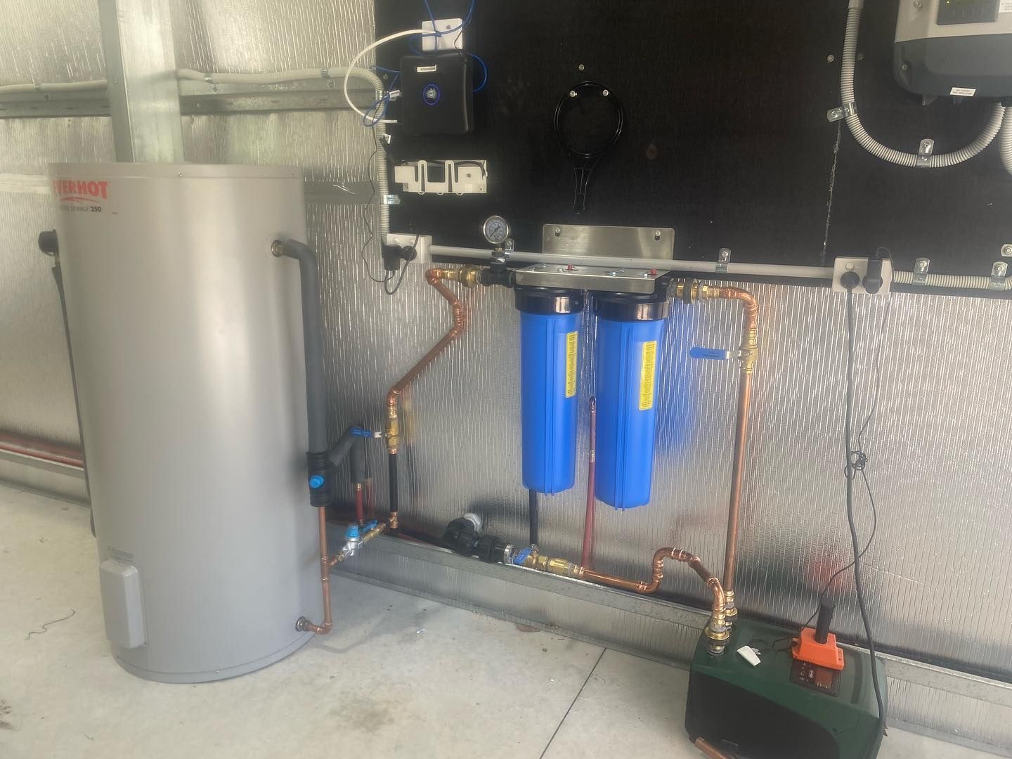 Utility Room With Tank, Two Filters, Pipes, and a Control Panel — Medowie Plumbing & Gas in in Maitland