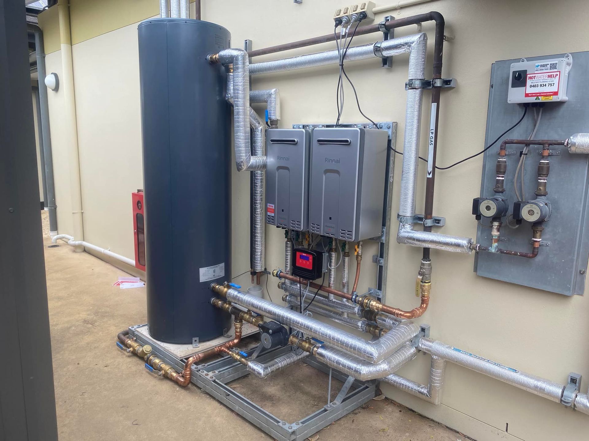 Water Heater System with A Tall, Black Tank, Two Gray Units — Medowie Plumbing & Gas in in Newcastle