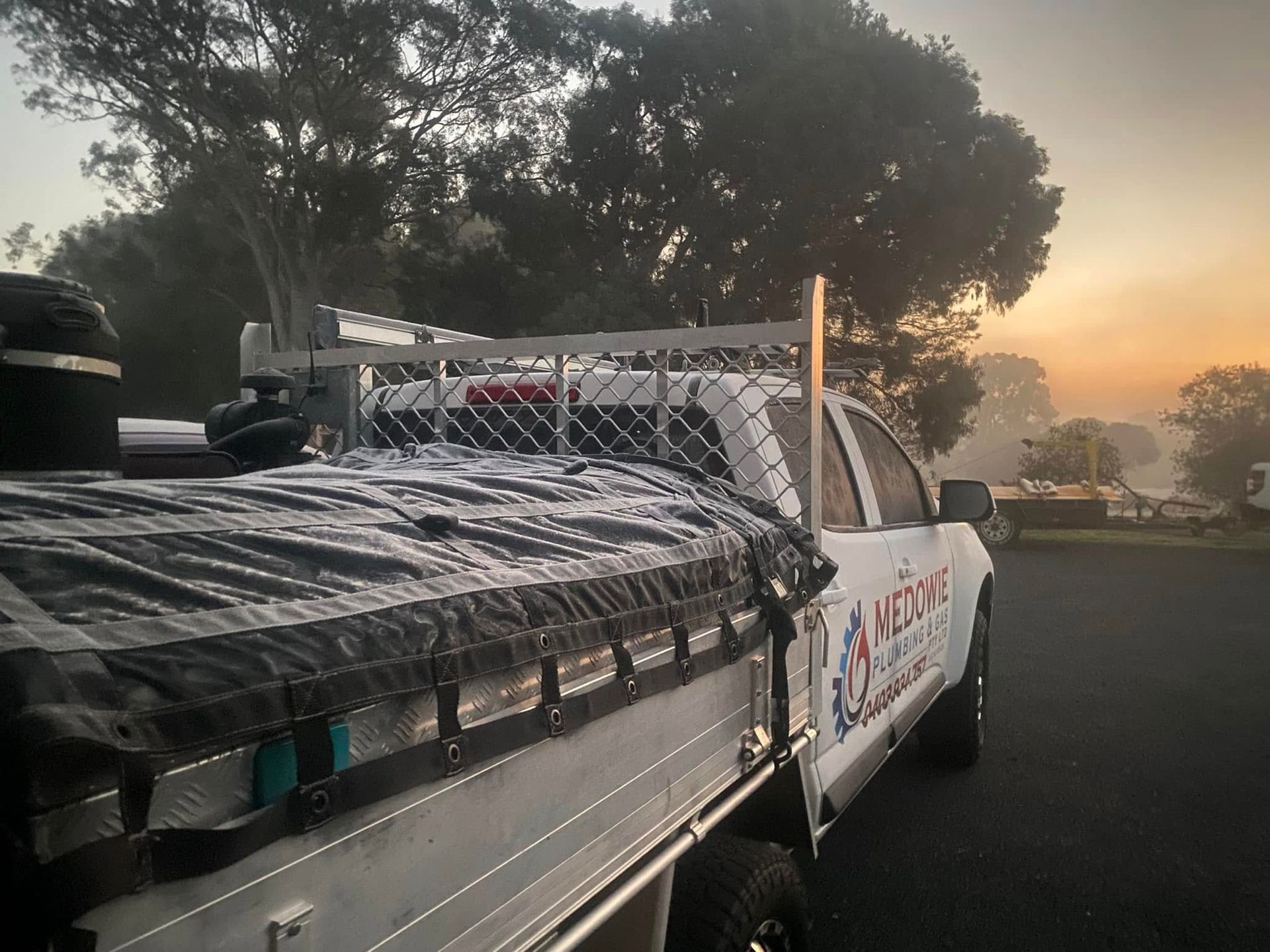 A Medowie Plumbing and Gas Truck Is Parked in Front of A Sunrise — Medowie Plumbing & Gas In Medowie, NSW