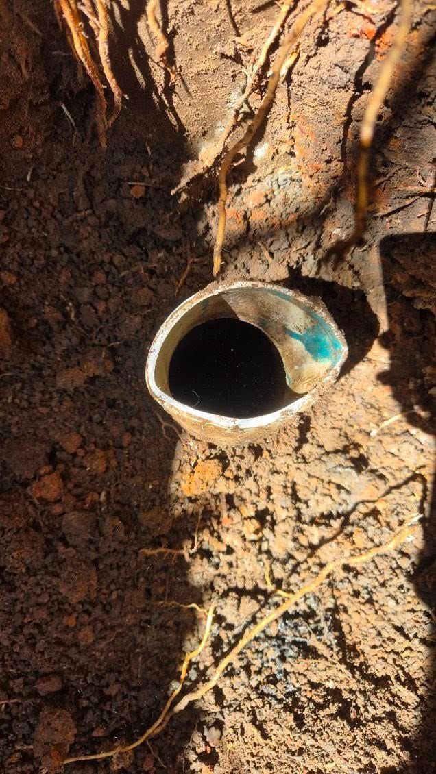 White PVC Pipe Opening in Brown Soil — Medowie Plumbing & Gas in in Newcastle
