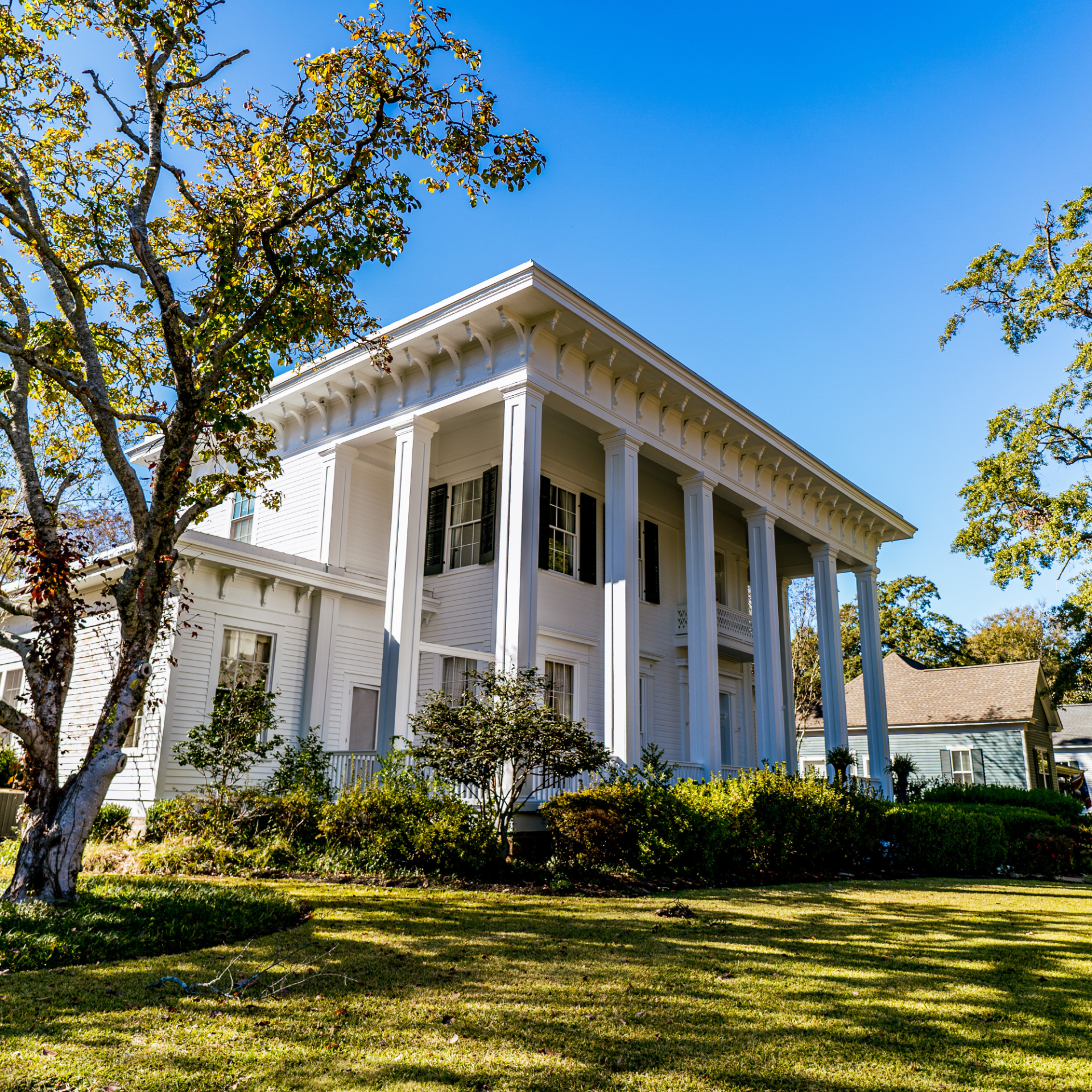 A large white house with columns and a porch