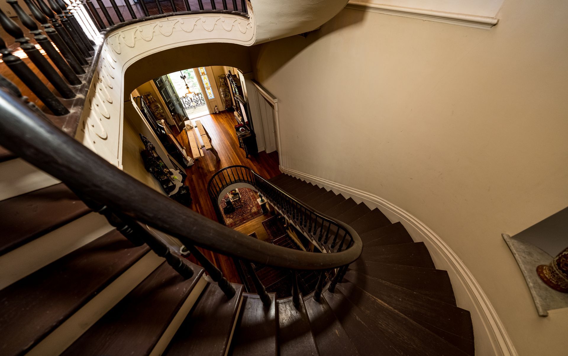 A view of a spiral staircase from the top of it