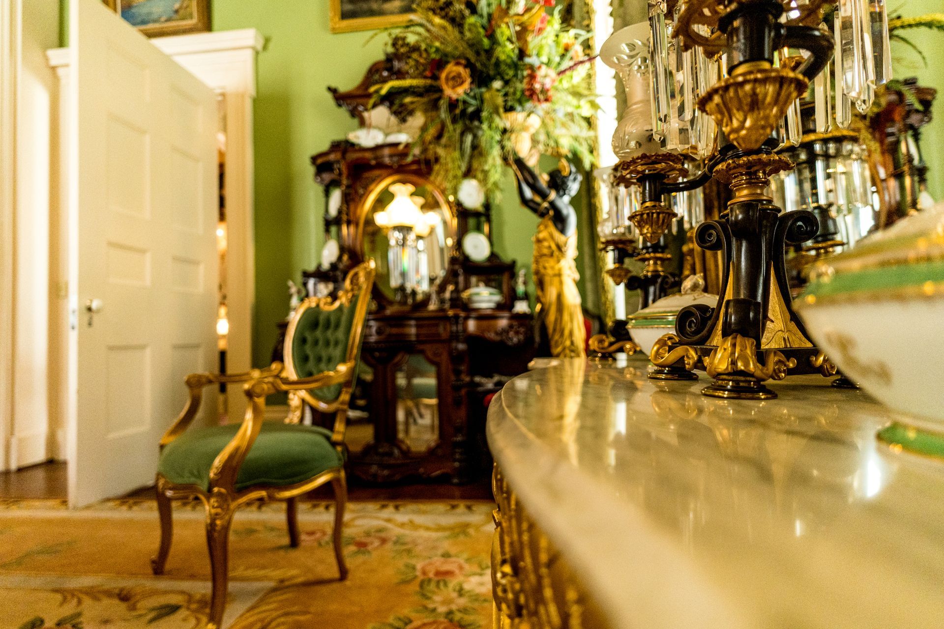 A room with a green chair and a clock on the wall