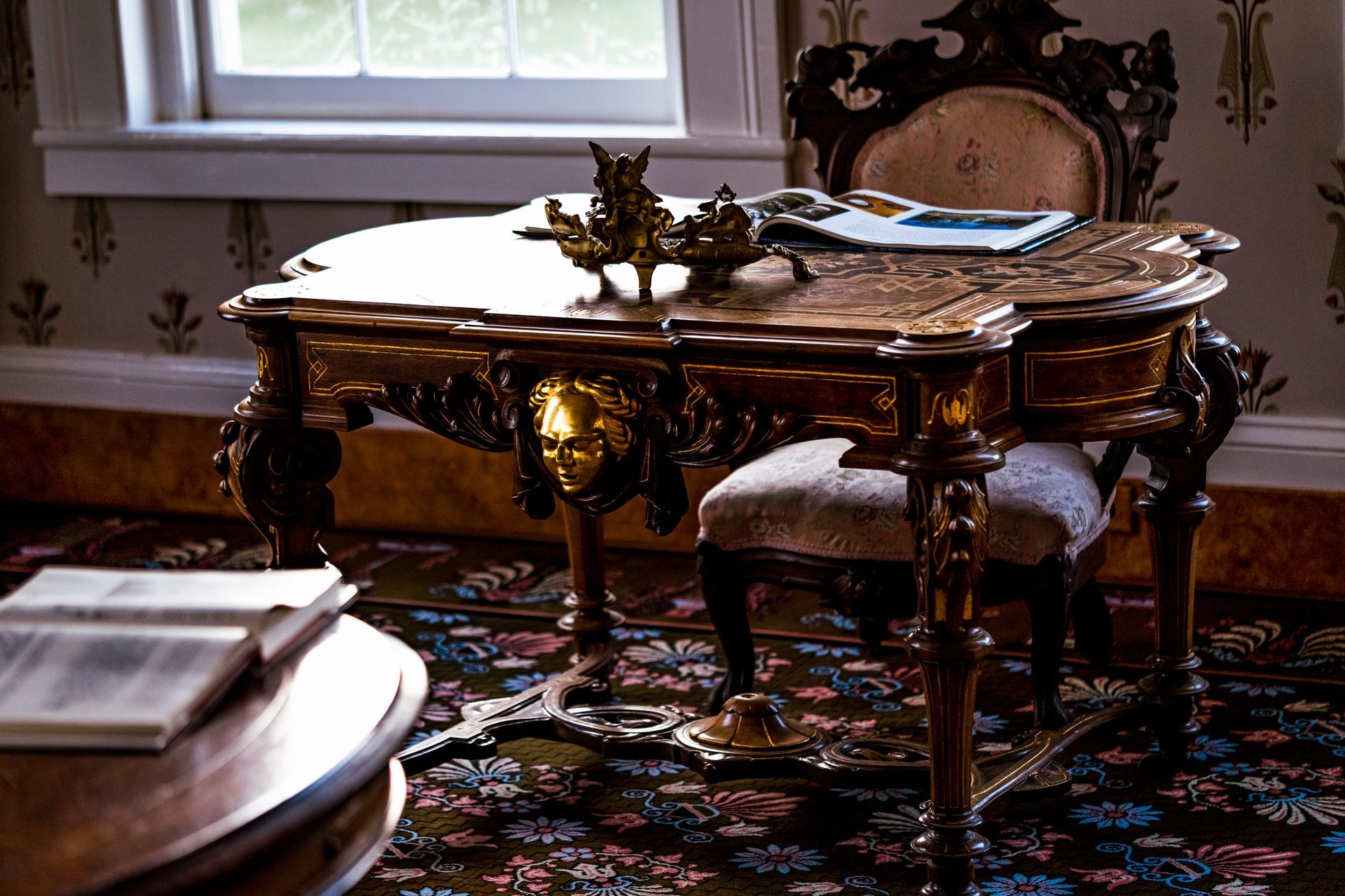 A room with a table and chairs and a window