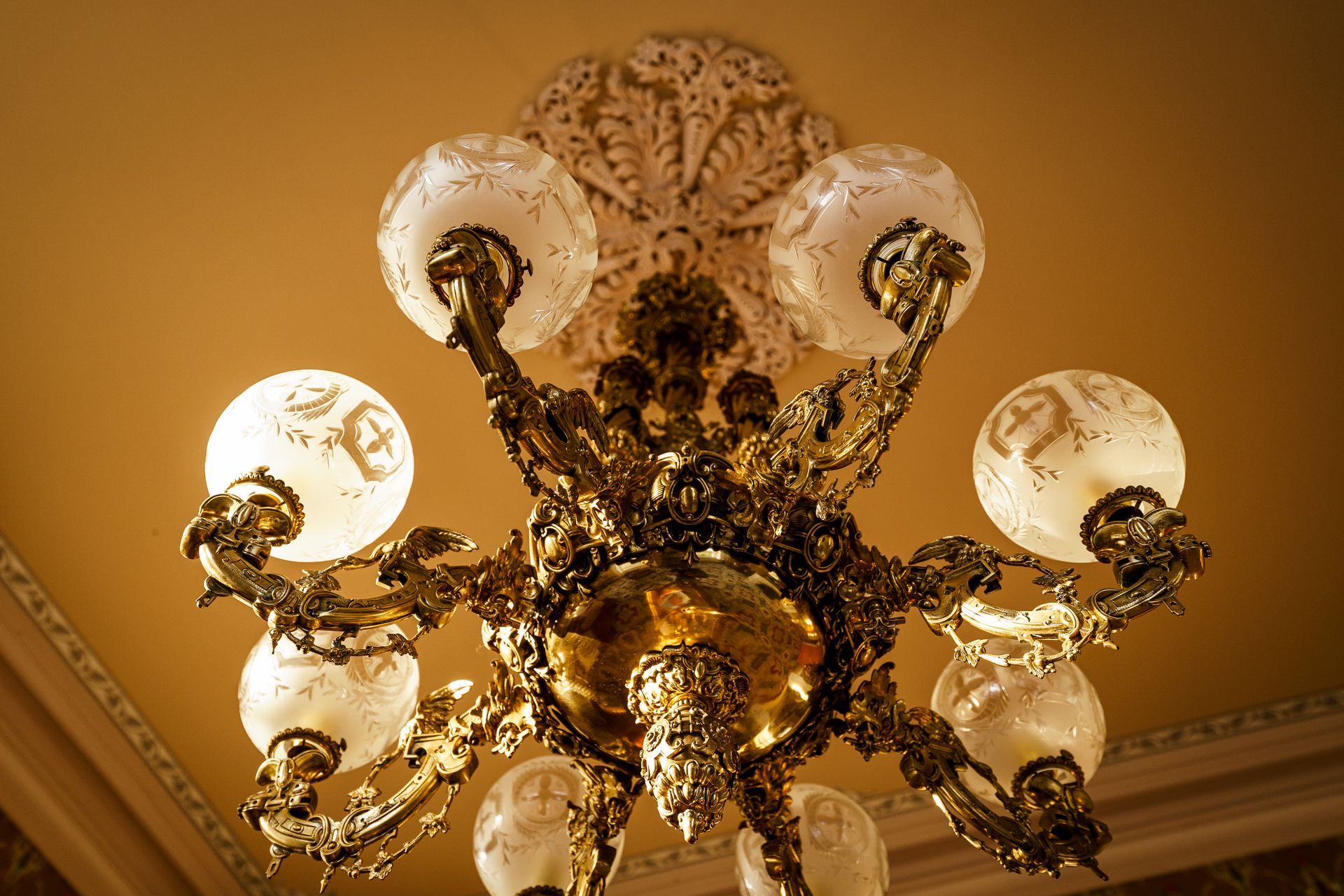A chandelier is hanging from the ceiling in a room