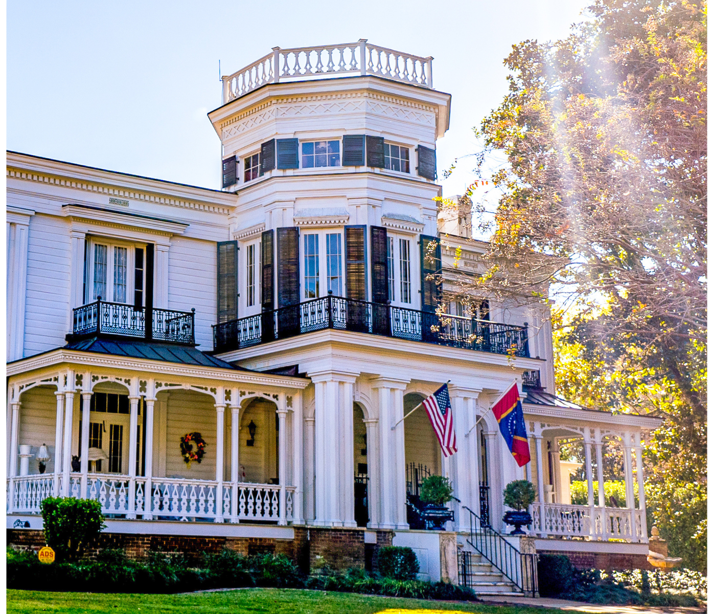 A large white house with a tower on top of it