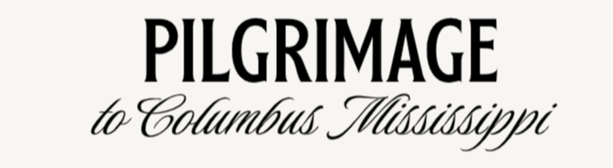 A black and white logo for pilgrimage to columbus mississippi