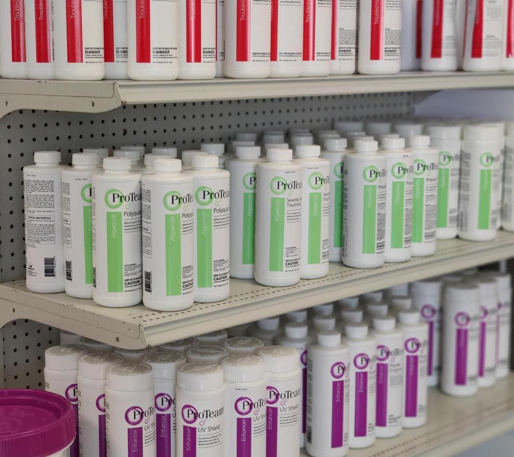 Shelves stocked with rows of pool maintenance supplies