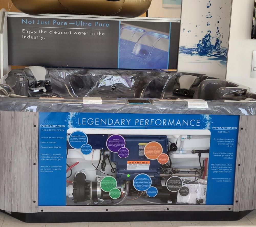 Tesla charging station with a blue “Legendary Performance” display and connected cables