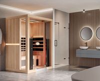 Modern bathroom with a glass sauna cabin, wood paneling, and a floating vanity with round mirrors