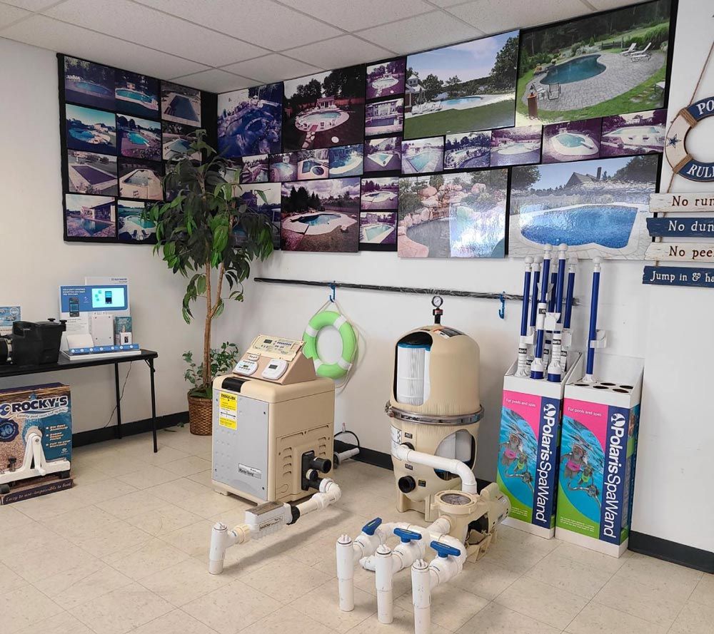 Clinic room with medical equipment, wall photos, and a white-and-green patient chair