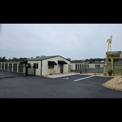 Windmill Storage facility with office building, storage units, and sign. The sign is a yellow windmill silhouette.