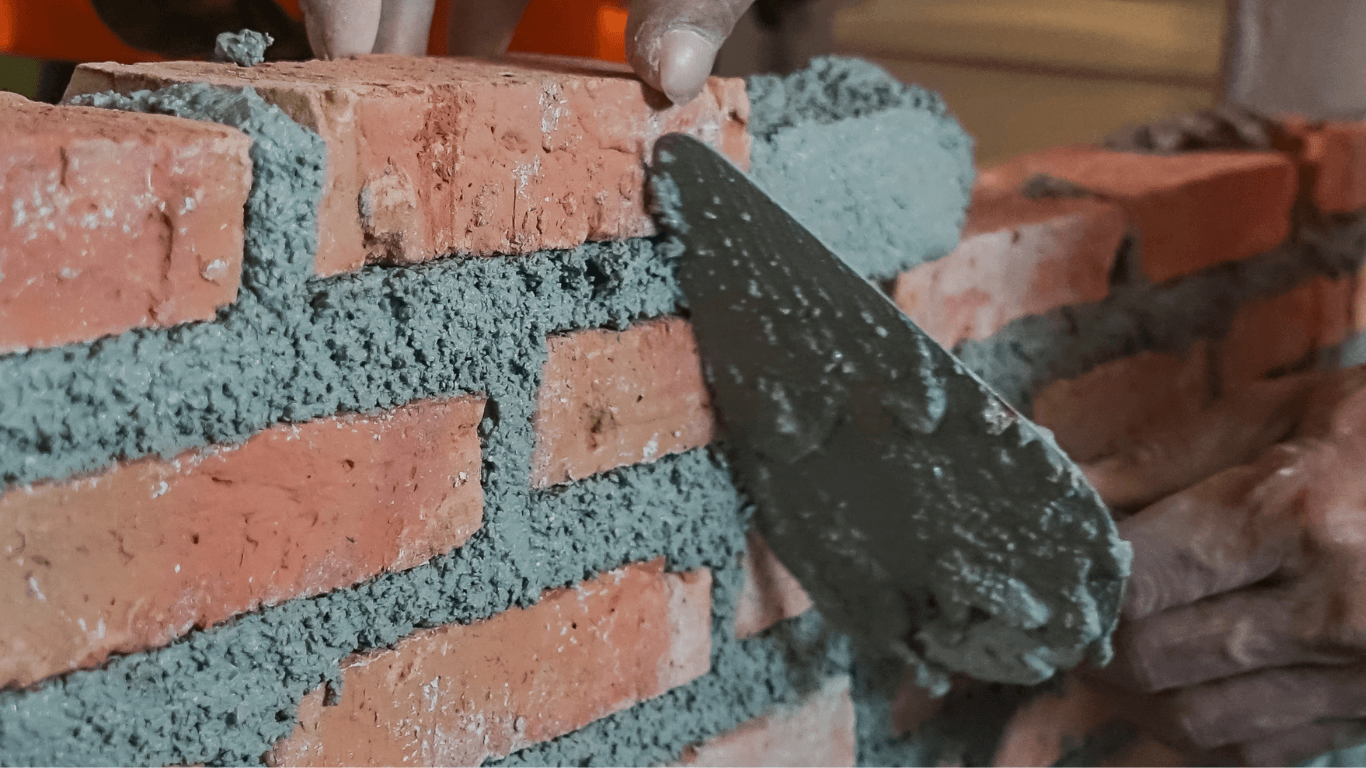 New brick wall construction with fresh mortar