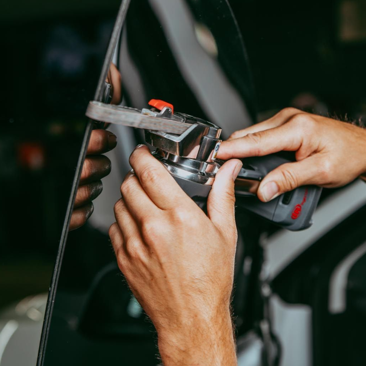 Hands repairing a bicycle handlebar with a wrench, close-up.