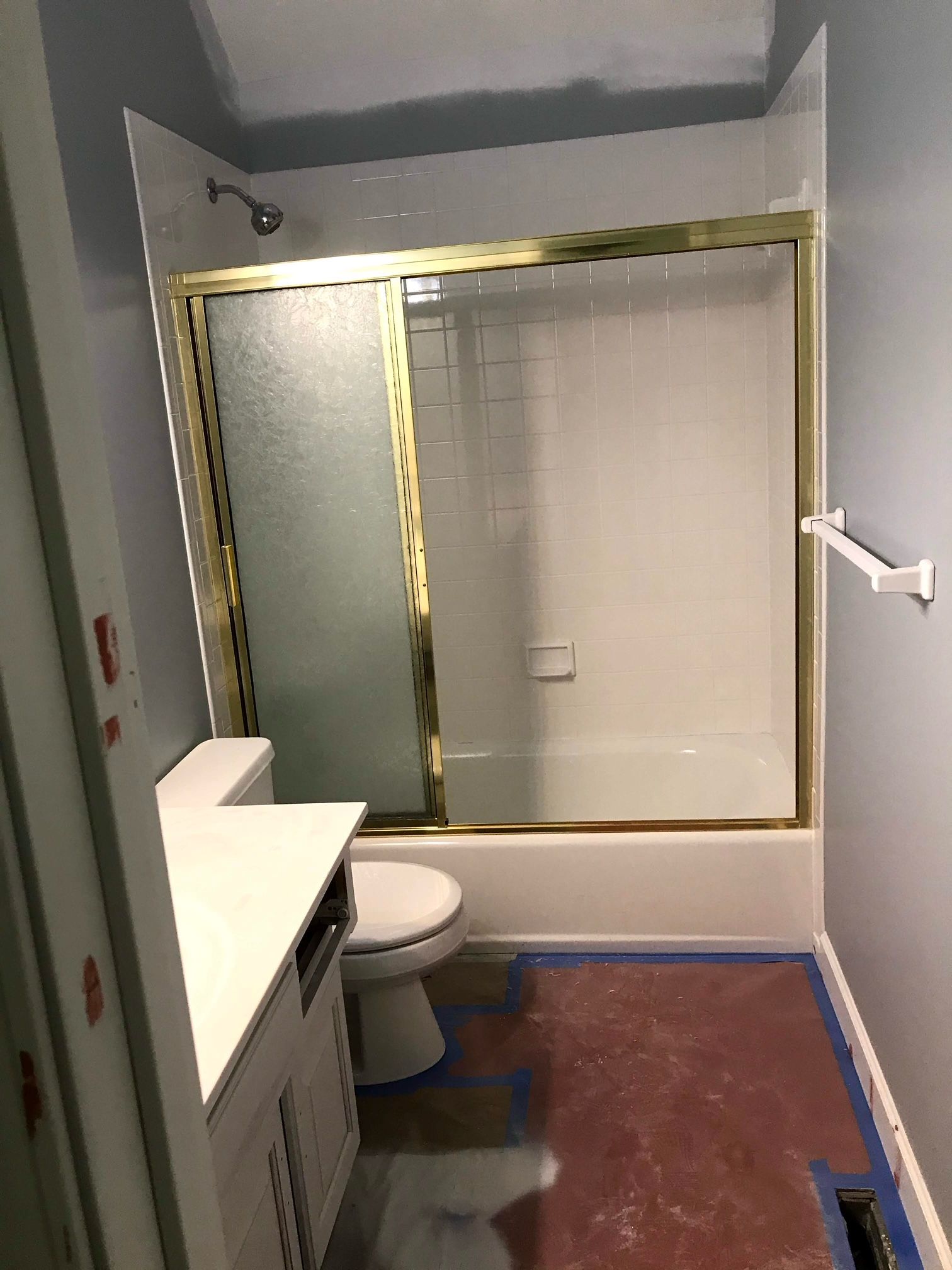A bathroom with a toilet , sink , shower and bathtub.