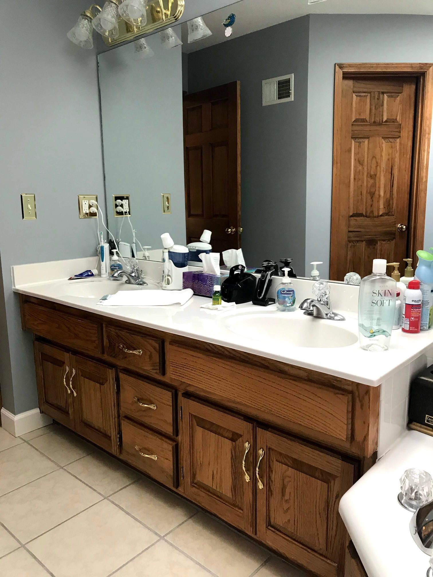 A bathroom with two sinks and a large mirror