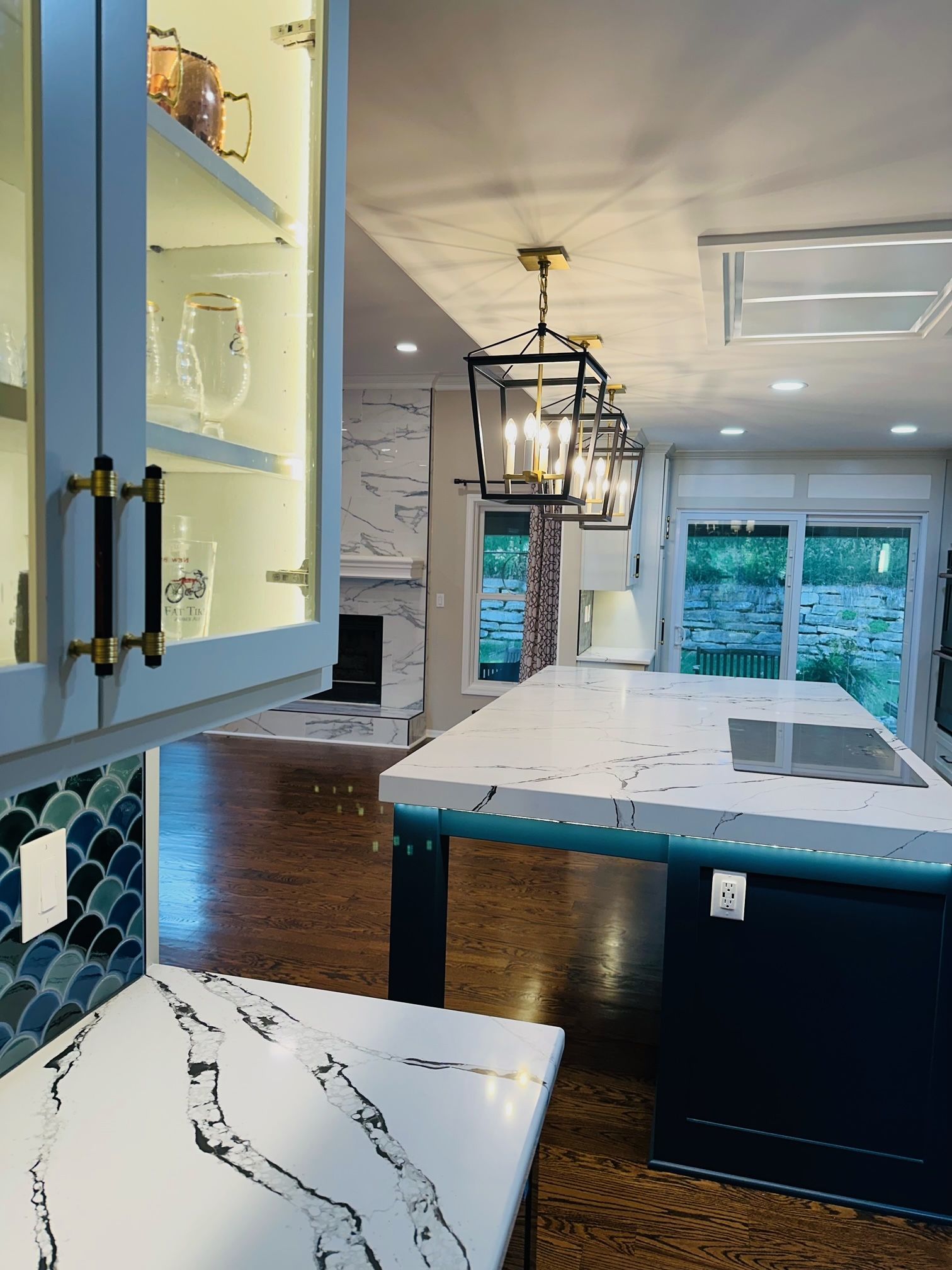 A kitchen with a large island and a stove top oven.