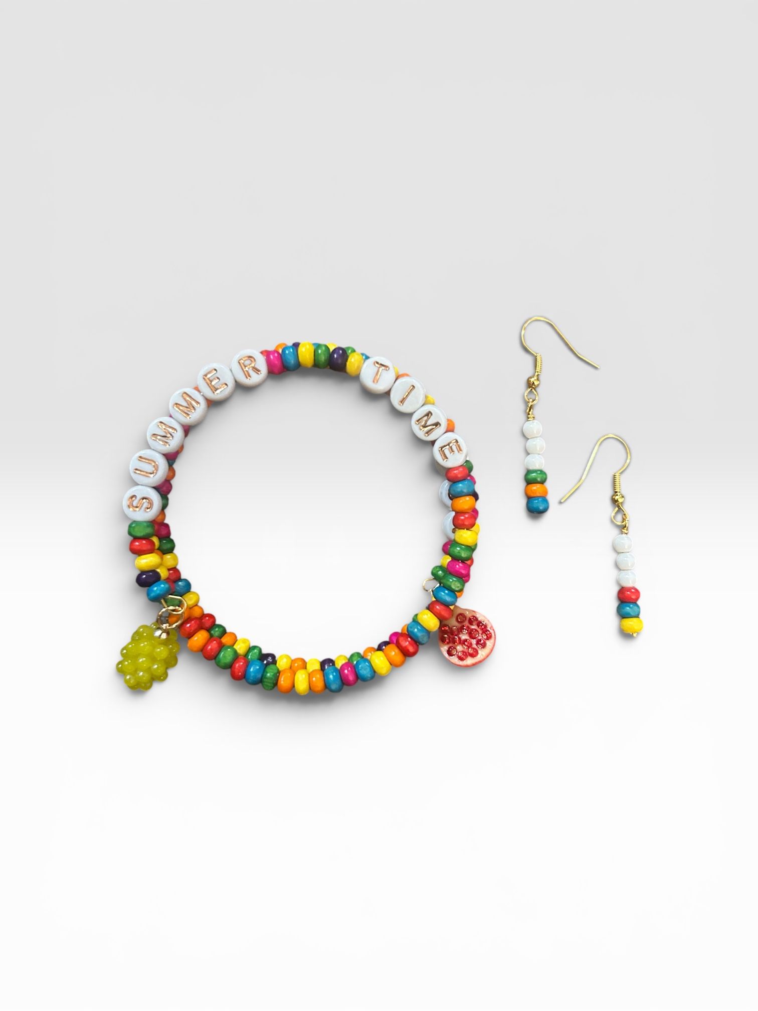 Colorful beaded necklace and matching earrings on a white background
