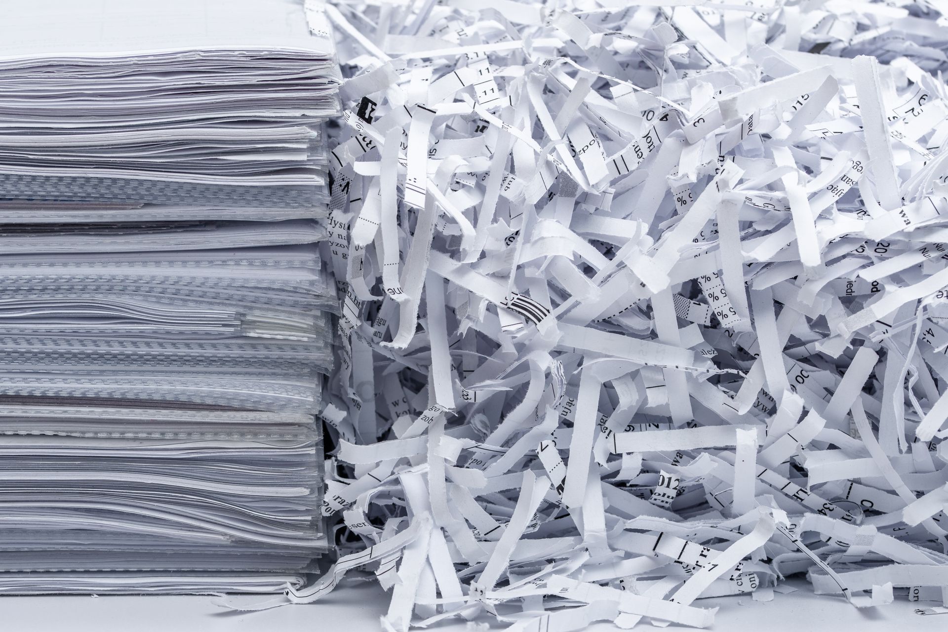 A pile of shredded paper next to a pile of shredded paper.