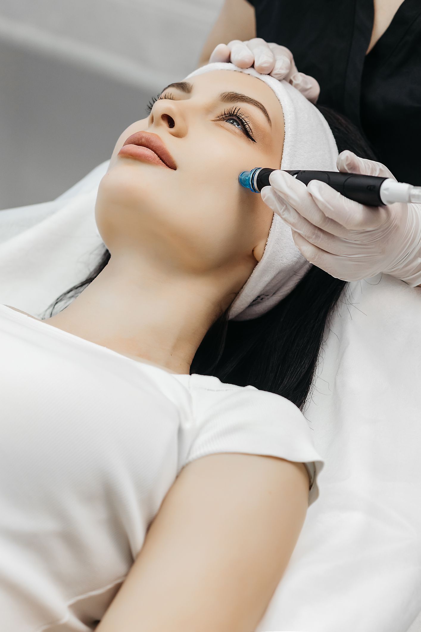 A woman is getting a facial treatment at a beauty salon.
