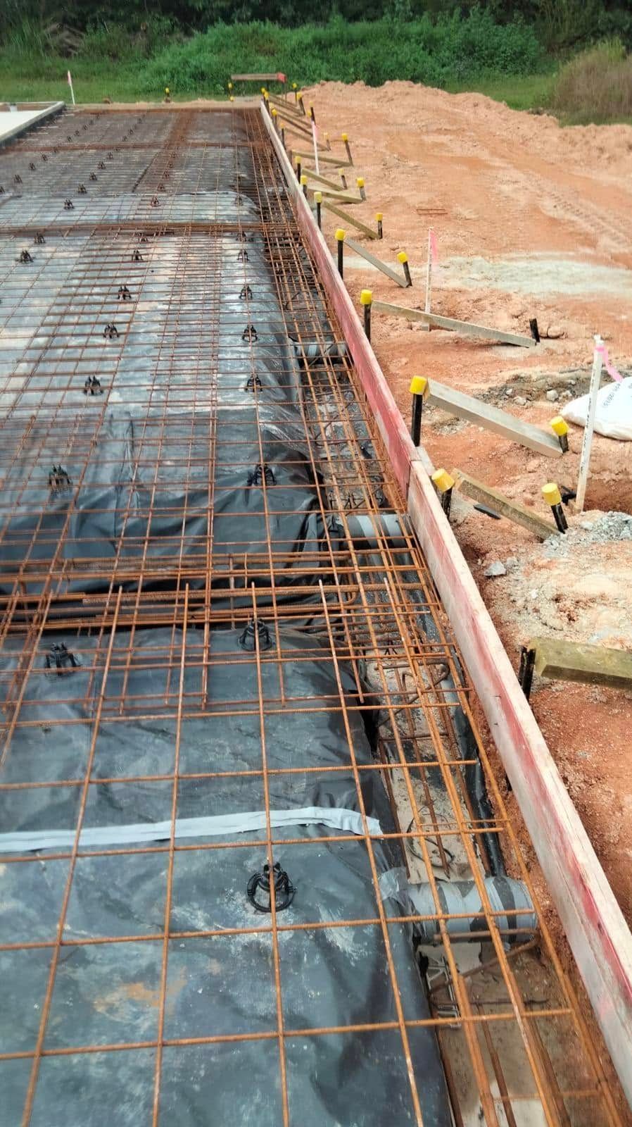 Worker Smoothing Wet Concrete With a Trowel on a Slab — King Reef Concrete in Babinda, QLD