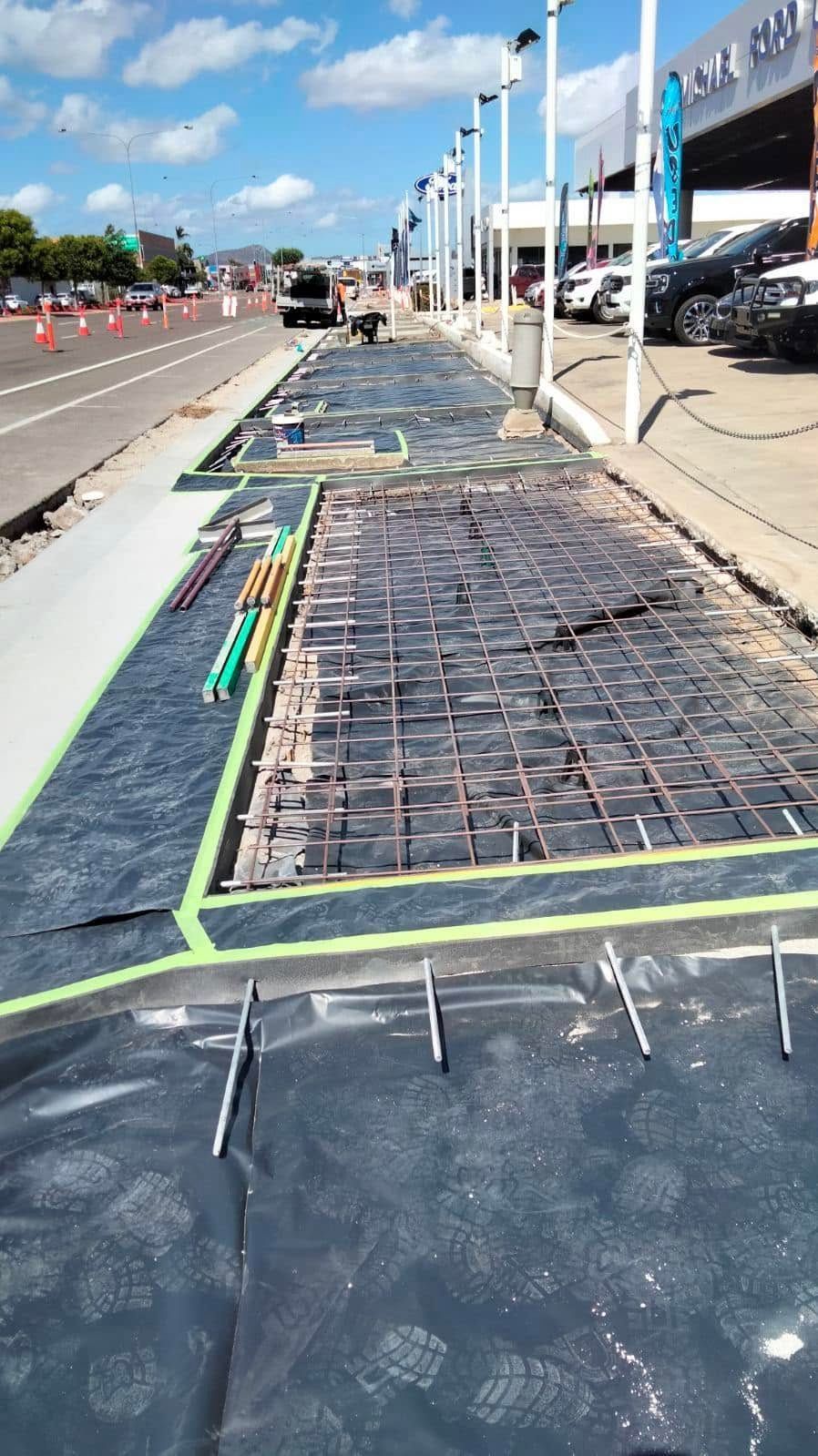 Sidewalk Construction With Exposed Rebar and Materials — King Reef Concrete in Kurrimine Beach, QLD