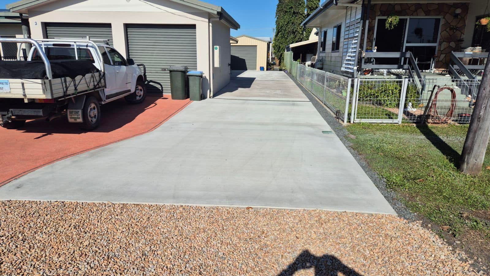 Worker Smoothing Wet Concrete on a Sidewalk Using a Long-handled Tool — King Reef Concrete in Cardwell, QLD