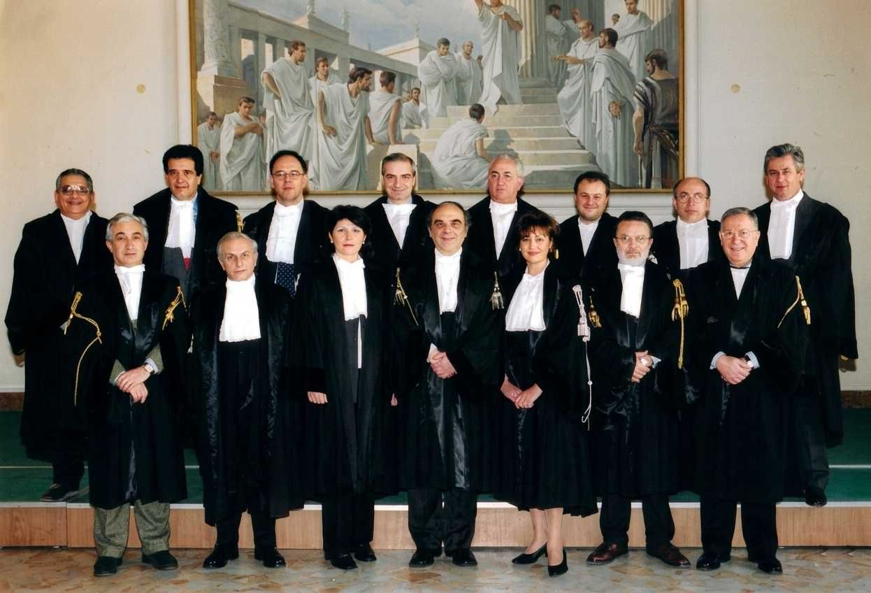 Due persone in abiti formali si stringono la mano, a simboleggiare un accordo o una collaborazione professionale.